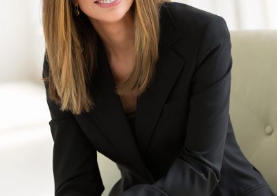 Stephanie Riggs in Black Pant Suit Sitting